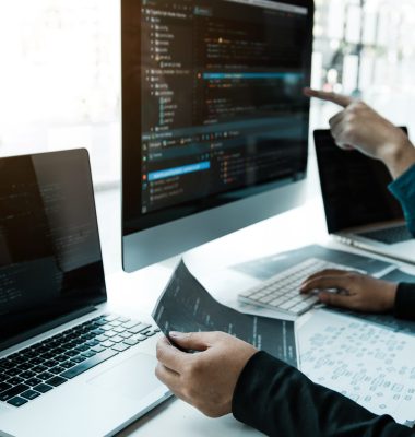 Two asian team working development of programming and encryption technology website design programmers on desk in office.